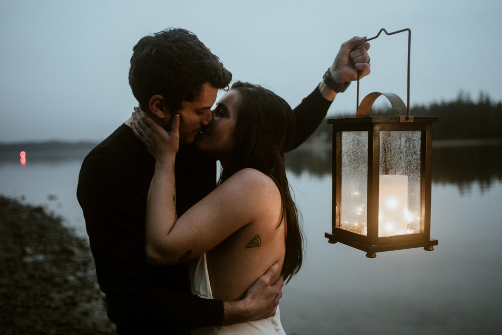 adventure elopement couple holding lantern on the Washington Coast 
