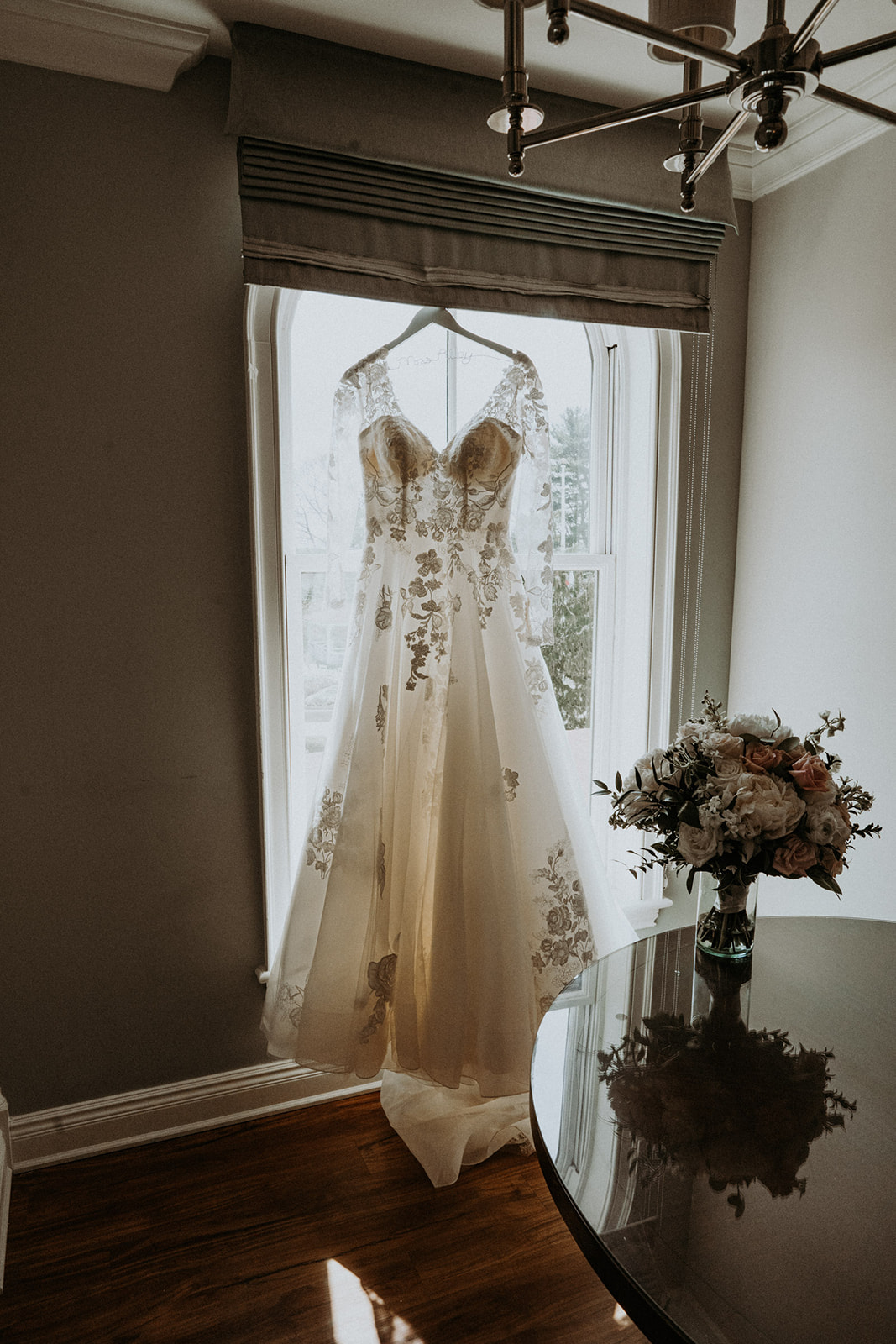 Lacy weddng dress hung in window