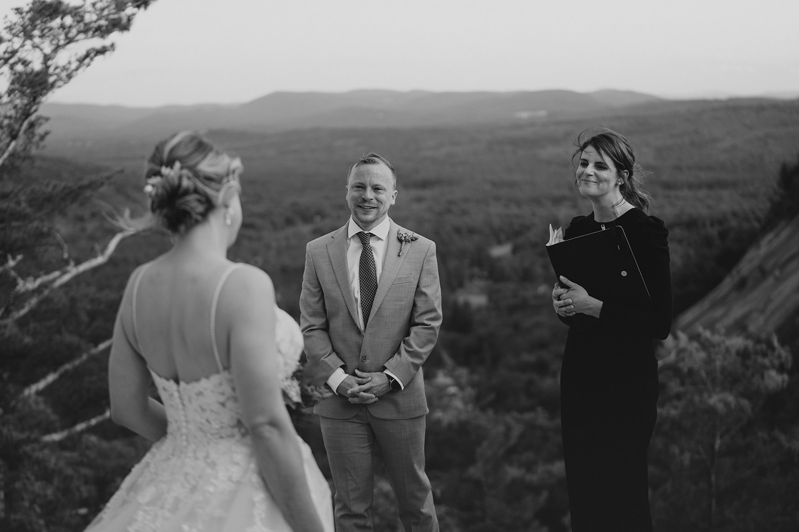 new Hampshire wedding couple stands on cathedral ledge in New Hampshire as they see each other for the first time on their wedding day